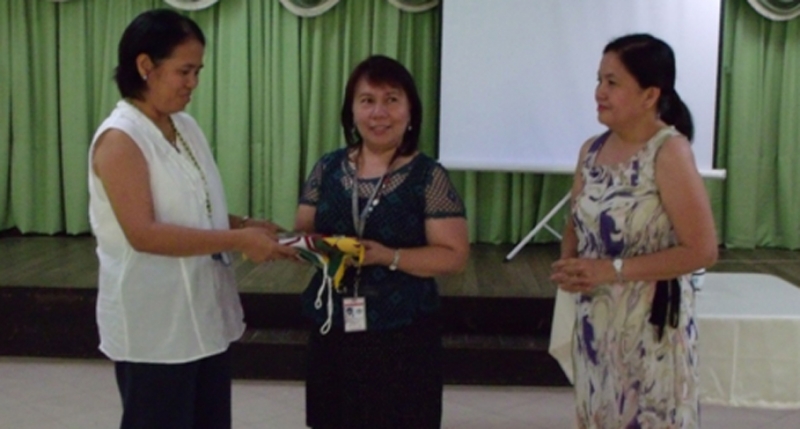 Incoming OSA Director Nina M. Cadiz (center) accepts the official OSA seal from Outgoing OSA Director Leticia E. Afuang (left) with Vice Chancellor for Academic Affairs Portia G. Lapitan during the turn over ceremony on June 1, 2015 at the Makiling Hall, Student Union Building.