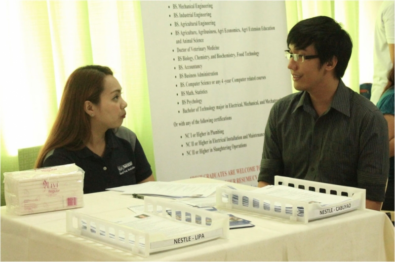 A representative from a participating company interviews an aspiring employee during the annual job fair.